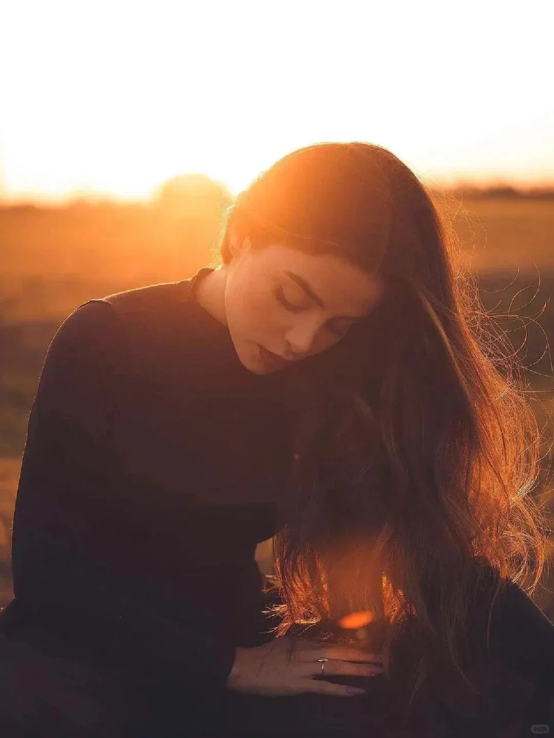 Woman with long hair in sunlight outdoors, sunset glow, healthy hair, natural beauty